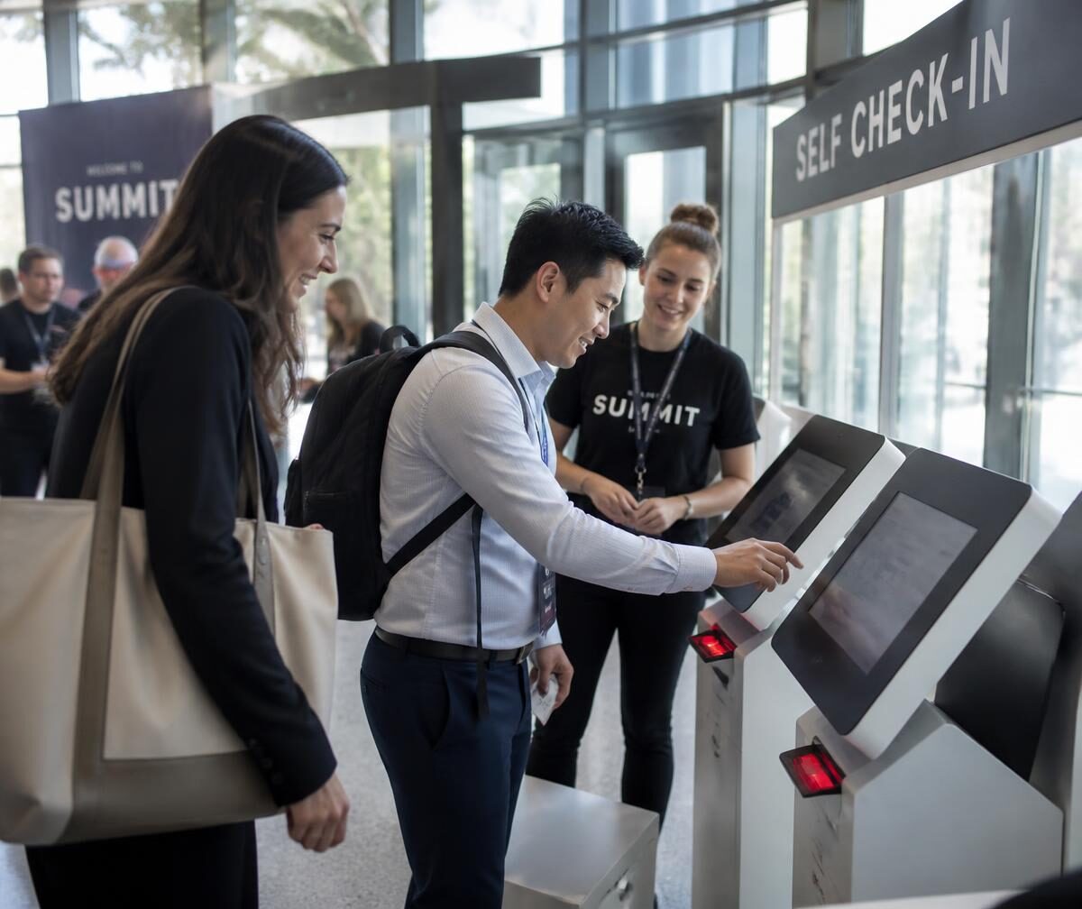 Attendees using a self check-in station at a conference